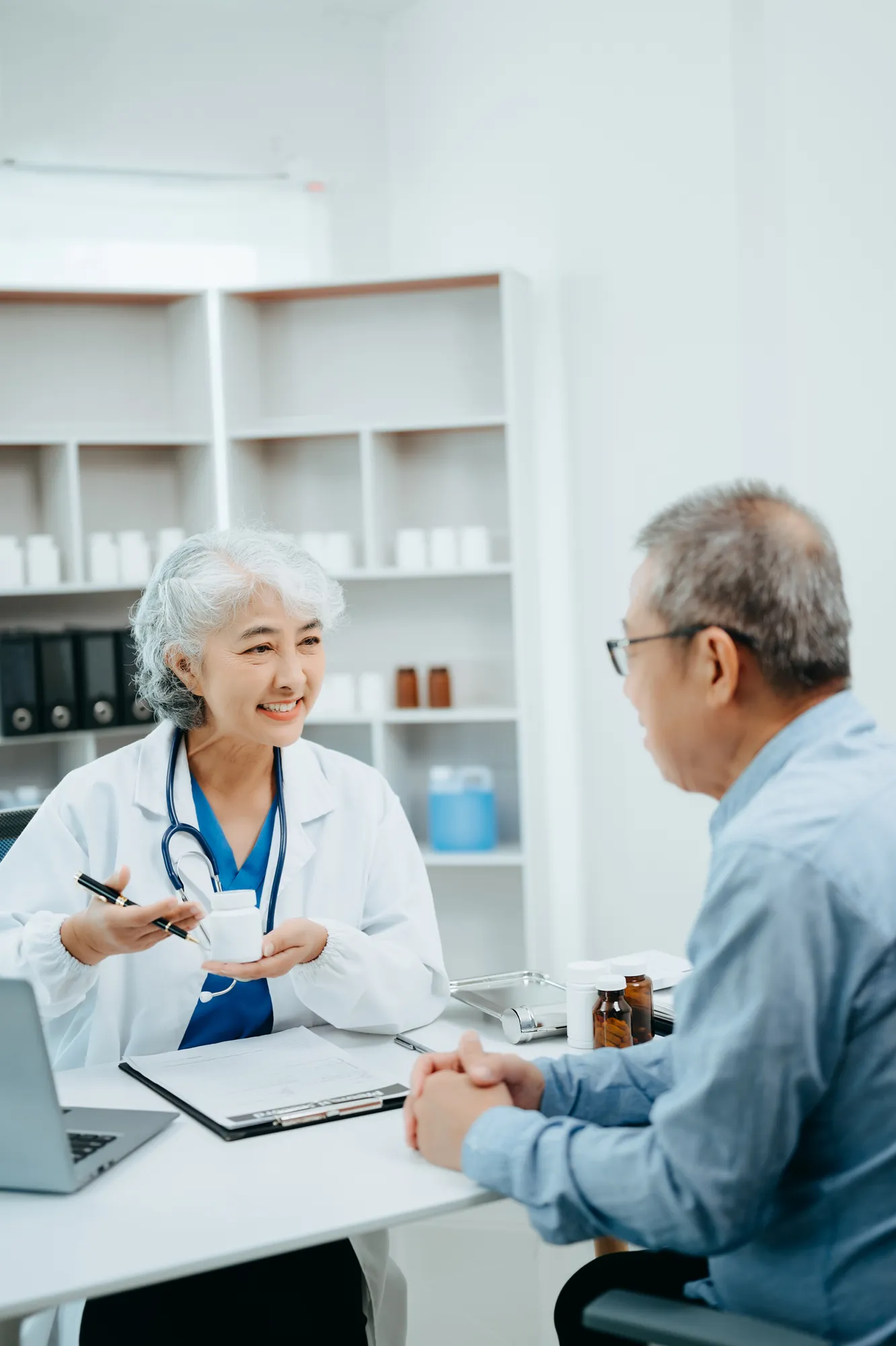 Smiling doctor talking with a senior male patient during an appointment